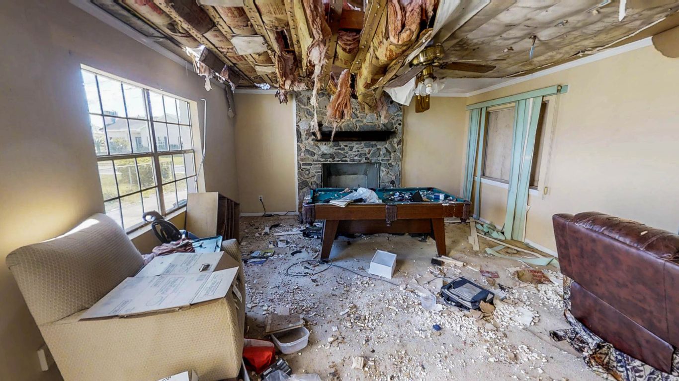 Severely damaged home interior during storm damage restoration in Bonita Springs after a major storm.